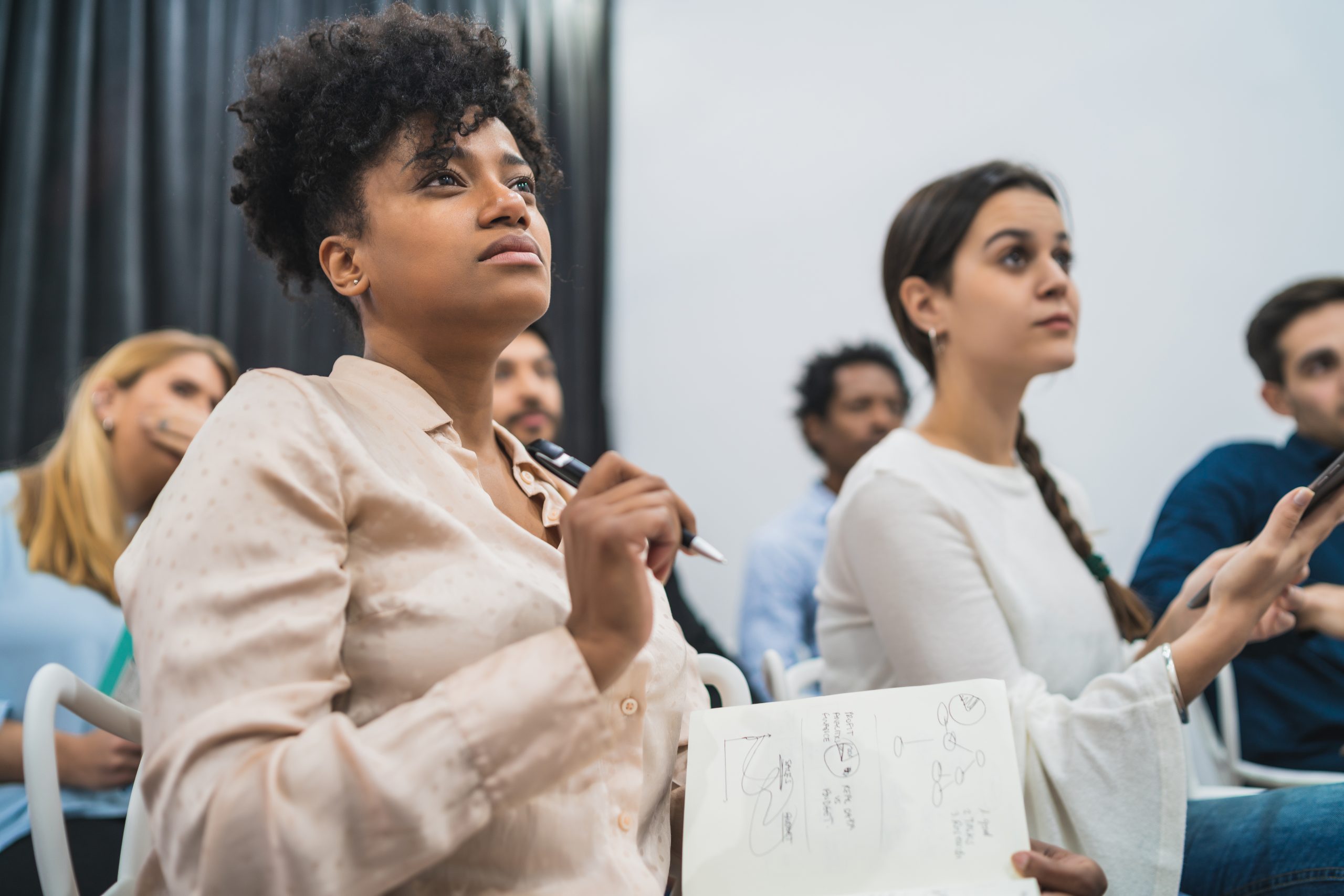 Multiethnic creative people having a brainstorming meeting. Group of multiethnic creative business people working on a project and having a brainstorming meeting. Team work and brainstorming concept.